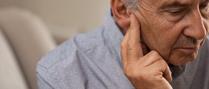 Senior man with hearing problems